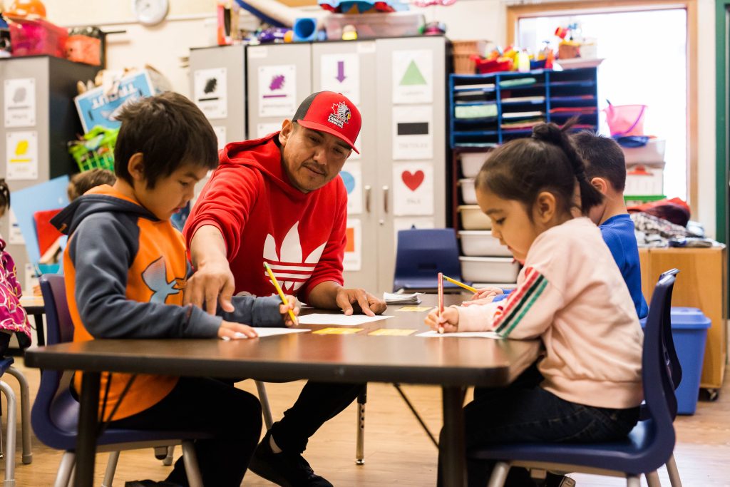 Young First Nations children in B.C. sit at a table in a language nest, a program that immerses them in their native language.